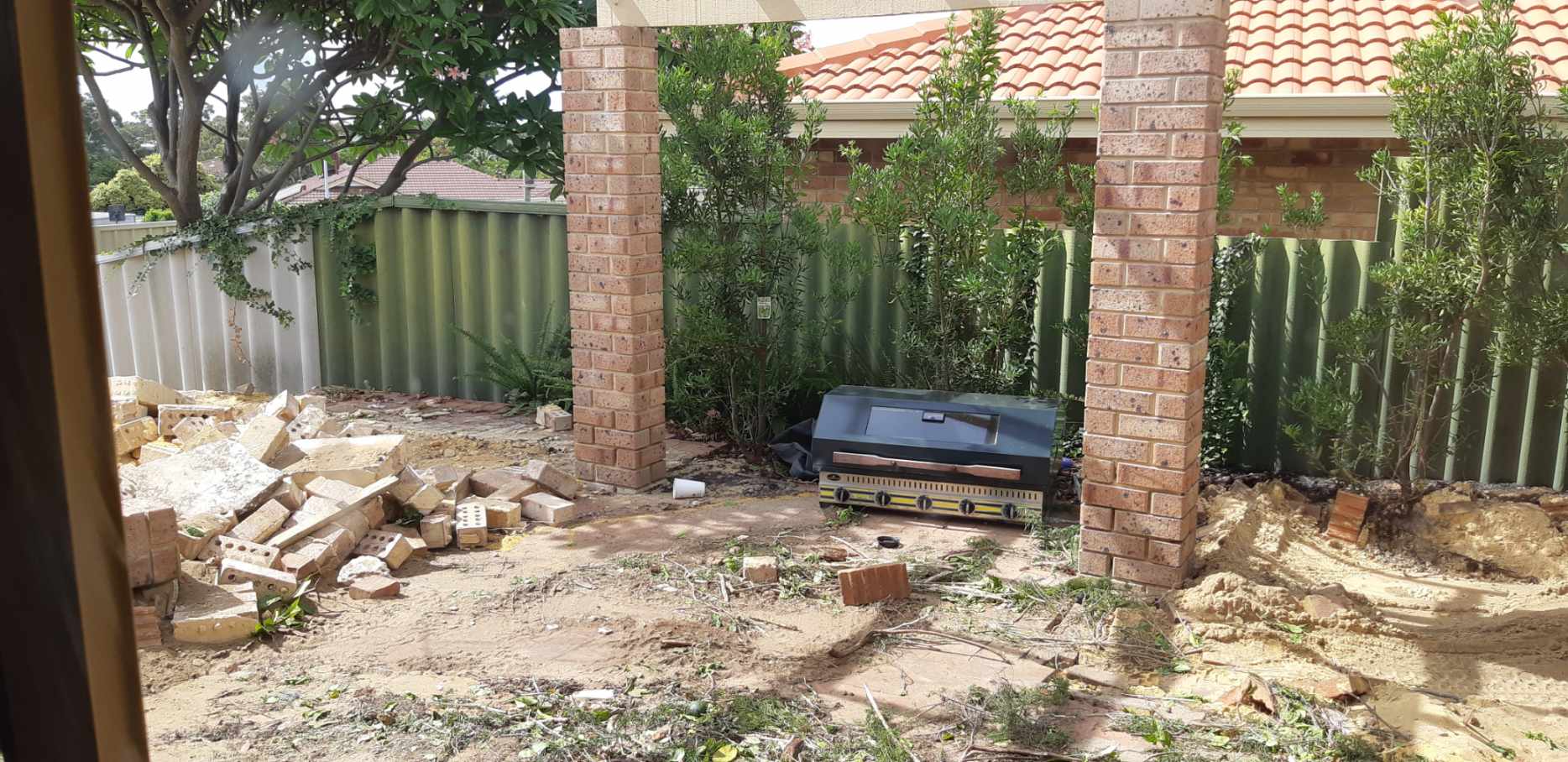 Outdoor removal work beside a house