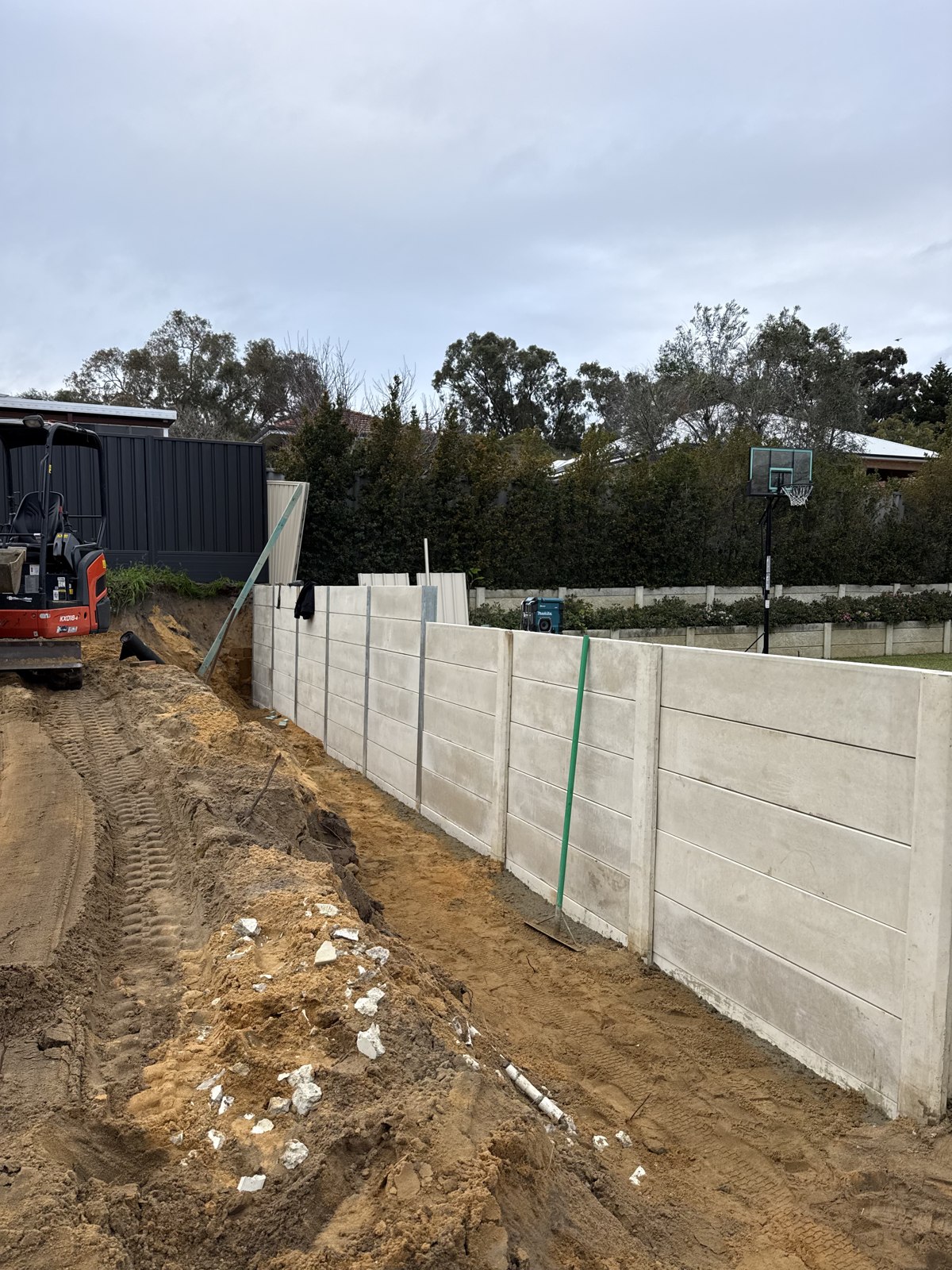 Concrete sleeper retaining wall and ground preparation