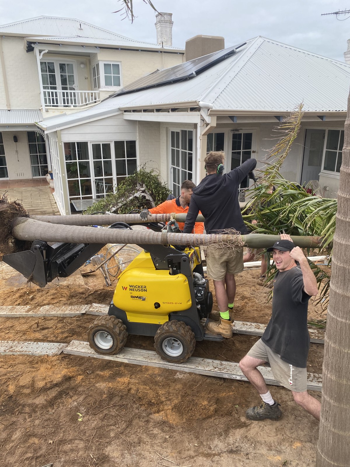 Crew and compact machinery working at a residential property